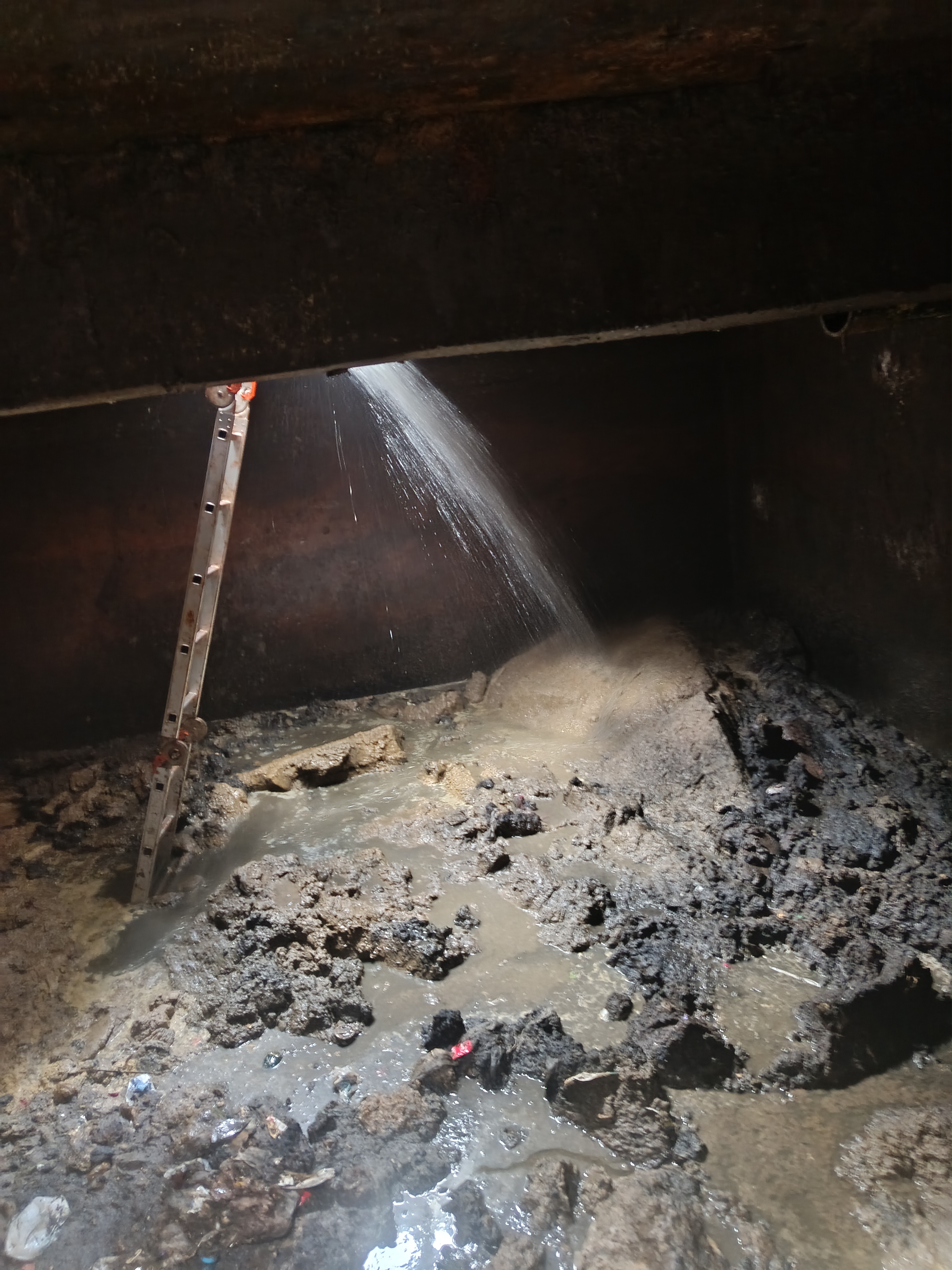 Septic tank before deep cleaning — heavy biofilm and sludge buildup